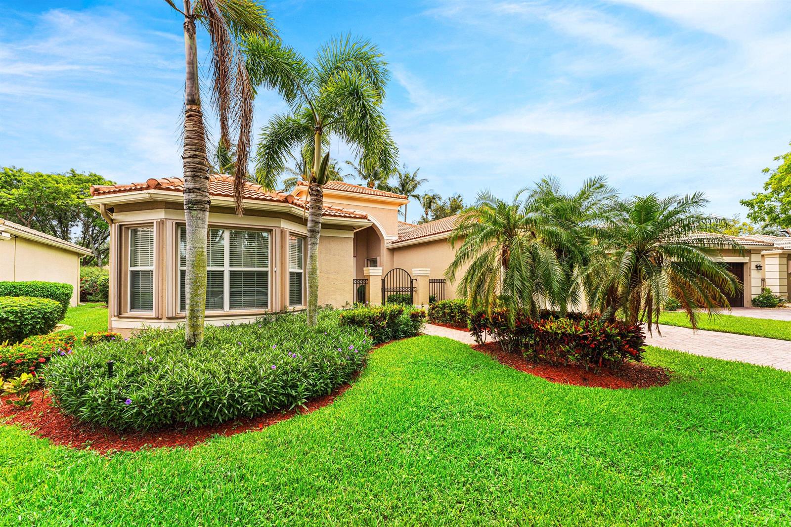A single-story house with a tile roof, palm trees, and a landscaped front yard — 6968 Corning Circle, Boynton Beach FL 33437, BOYNTON BEACH, FL