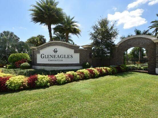 A stone entrance sign for Gleneagles Country Club sits behind a landscaped garden and lawn — 7449 Glendevon Lane # 106, Delray Beach FL 33446, DELRAY BEACH, FL