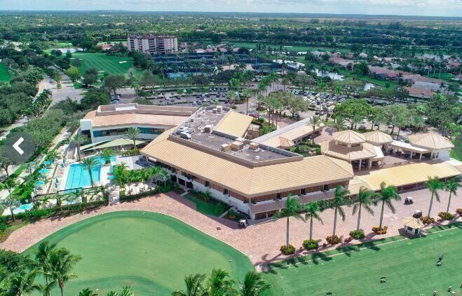 An aerial view shows a large clubhouse with a swimming pool and surrounding golf course — 7449 Glendevon Lane # 106, Delray Beach FL 33446, DELRAY BEACH, FL
