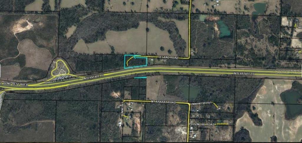 This aerial map shows a parcel of land outlined in blue adjacent to Interstate 10 — LELAND RD, MARIANNA, FL