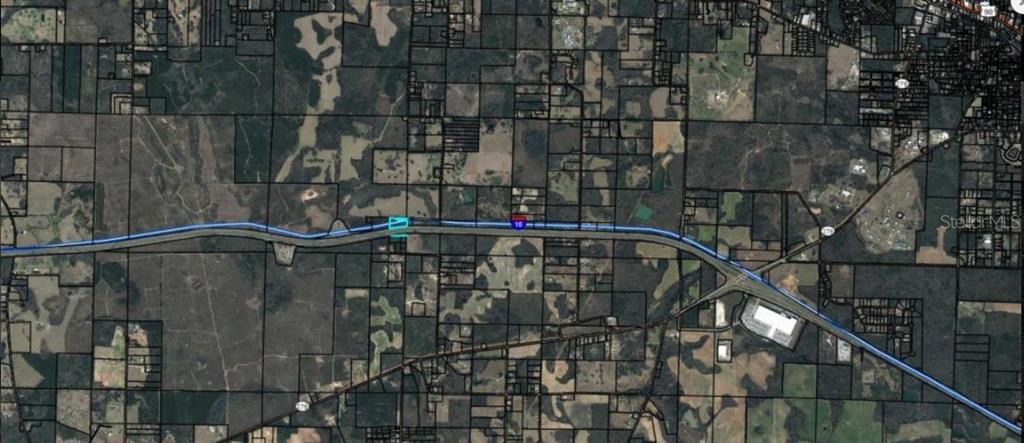 This is an aerial map showing property boundaries along a highway — LELAND RD, MARIANNA, FL
