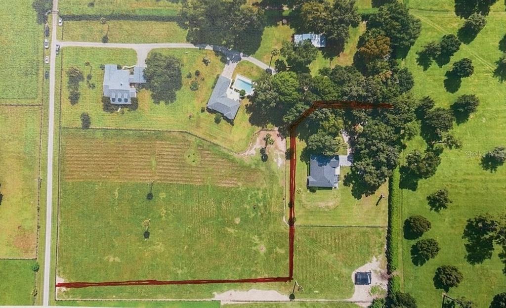 This aerial view shows multiple houses on a large, grassy lot with a red-lined boundary — 7137 & 7141 S MAGNOLIA AVENUE, OCALA, FL