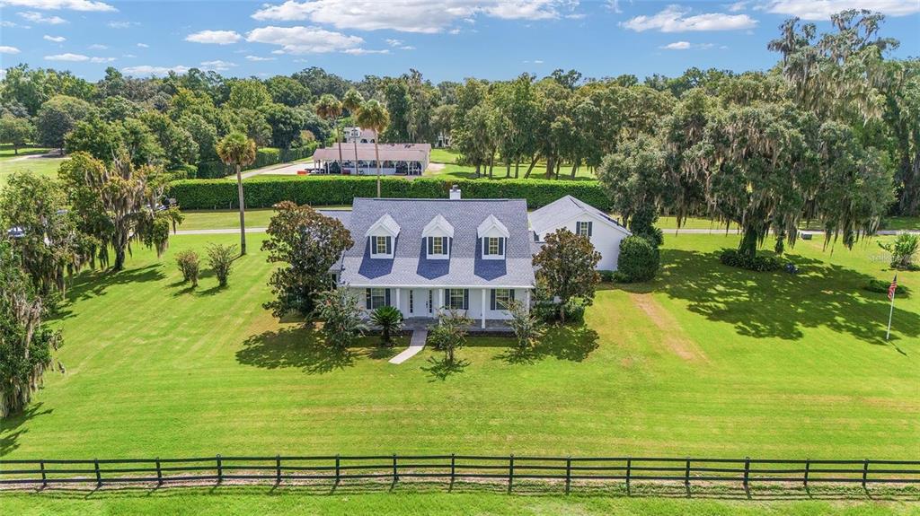 An aerial view of a two-story house with a gray roof and dormer windows — 7137 & 7141 S MAGNOLIA AVENUE, OCALA, FL
