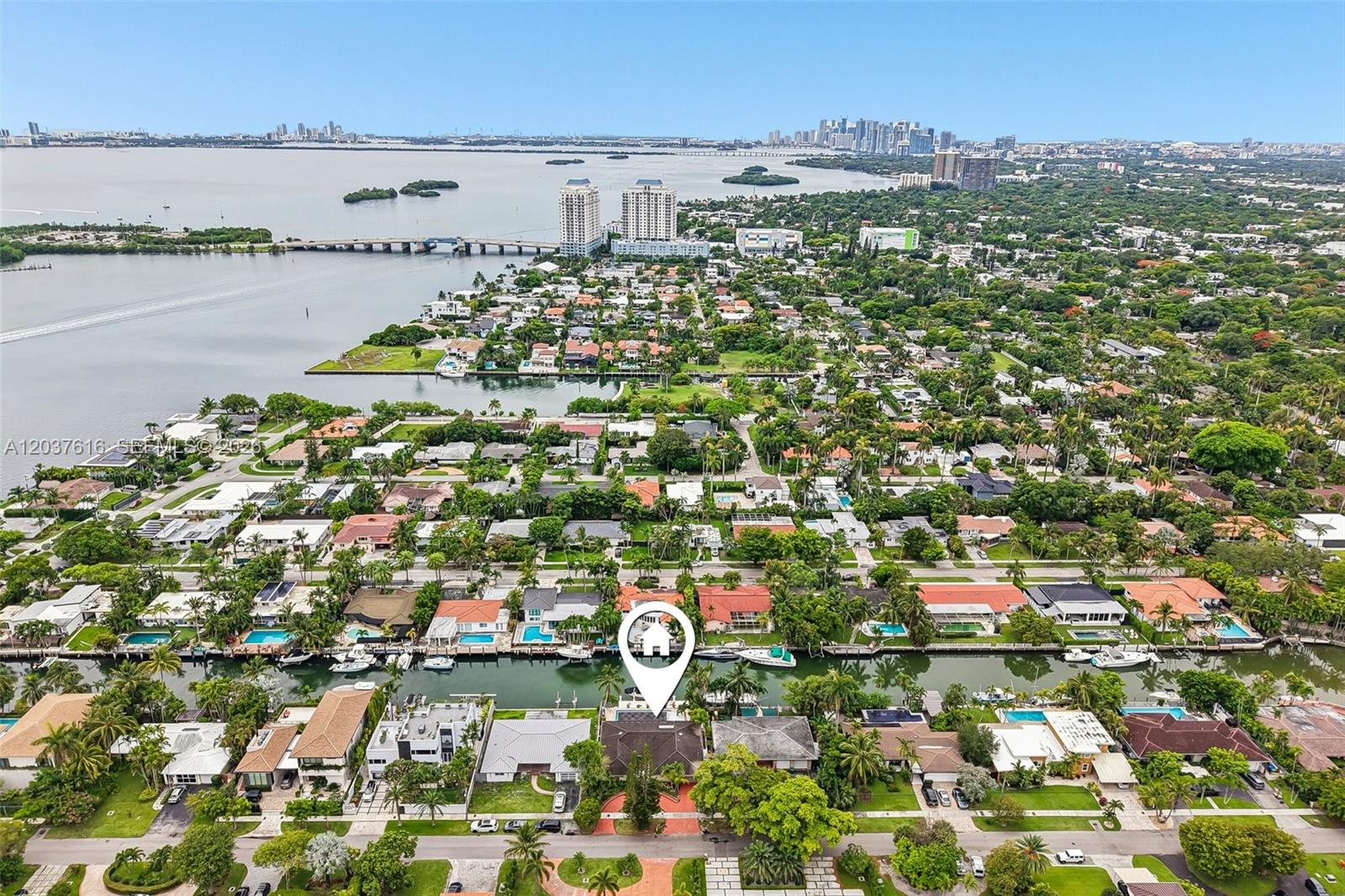 An aerial view shows a waterfront house with a pool along a canal in Miami — 1140 NE 87th St, Miami FL 33138, MIAMI, FL
