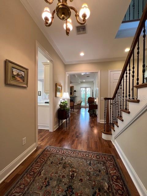 A foyer with hardwood floors, a chandelier, a staircase, and a view into another room — 622 PENN PLACE, WINTER PARK, FL