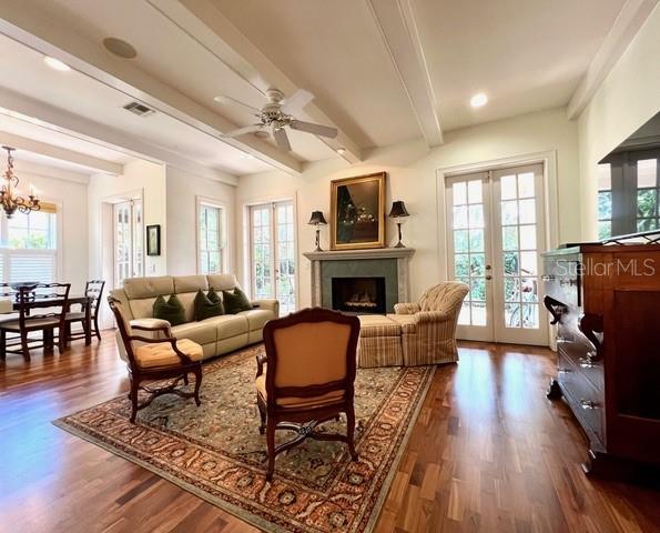 A living room features a fireplace, a sofa, two armchairs, and hardwood floors — 622 PENN PLACE, WINTER PARK, FL
