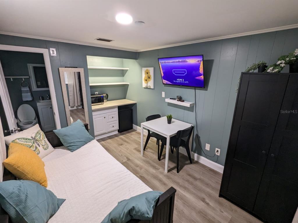 A small studio room features a daybed, a dining table, a kitchenette, and a bathroom — 4538 W MINNEHAHA STREET UNIT C, TAMPA, FL