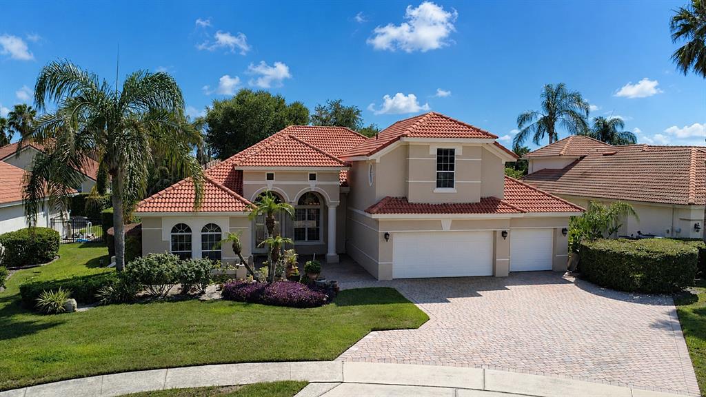 A two-story suburban house with a red tile roof and a paved driveway — 1954 ELKHORN COURT, LONGWOOD, FL