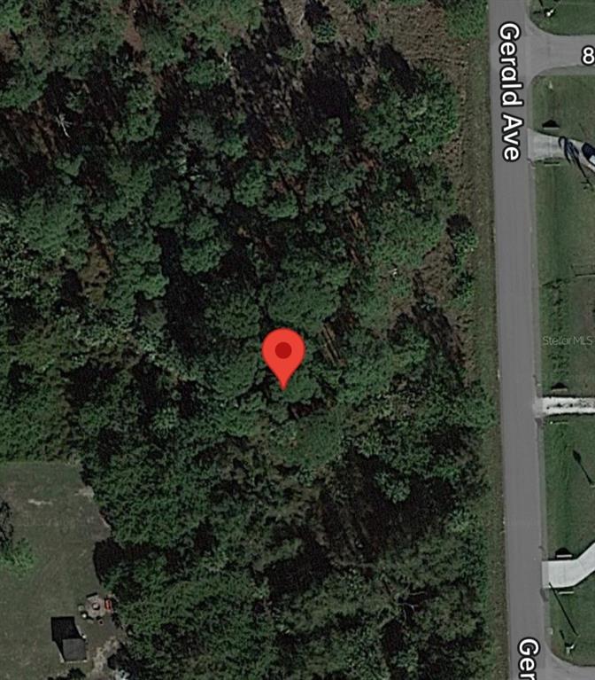 This is a satellite map view showing a wooded lot next to a paved road — 809 GERALD AVENUE, LEHIGH ACRES, FL