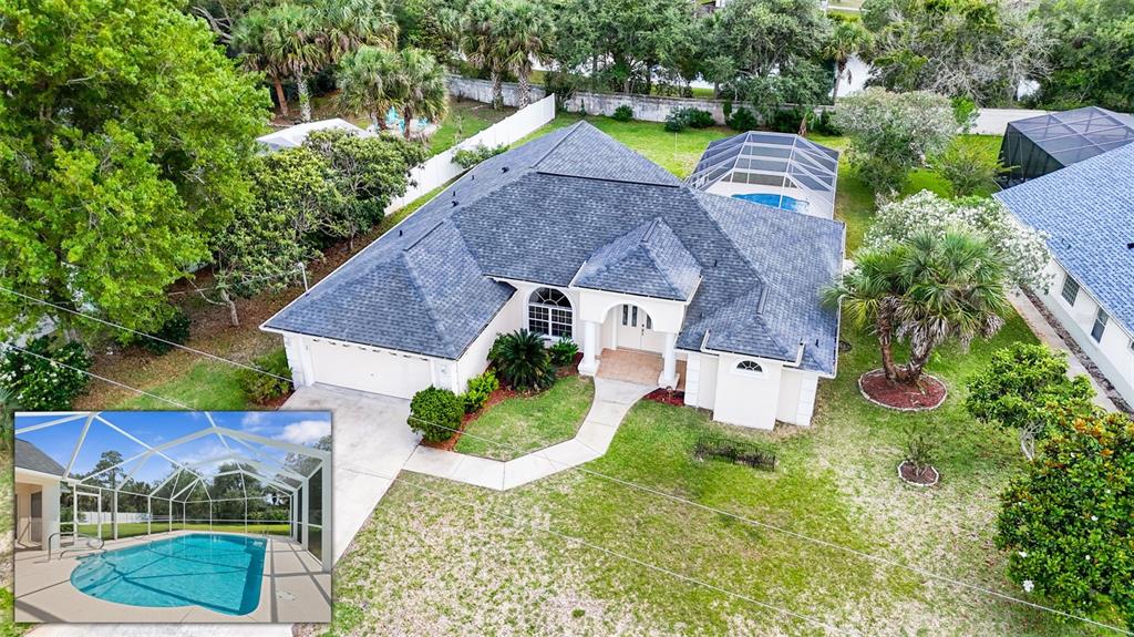 An aerial view shows a single-story house with a screened pool and a large yard — 14 COLECHESTER LANE, PALM COAST, FL