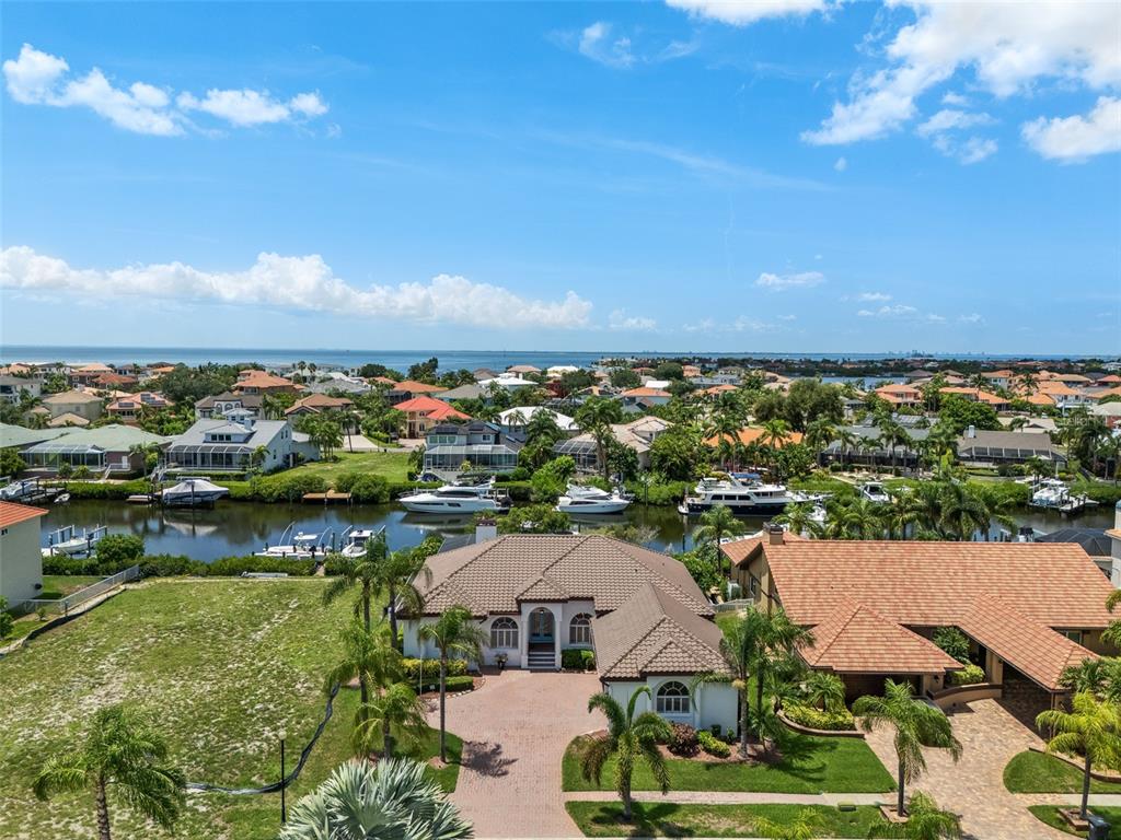 An aerial view of a waterfront home with a tile roof, driveway, and boat dock — 949 ALLEGRO LANE, APOLLO BEACH, FL
