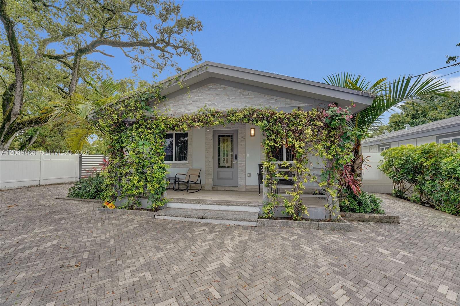 A single-story house with a stone facade, a covered porch, and climbing vines — 4541 SW 26th Ter # 0, Dania Beach FL 33312, DANIA BEACH, FL
