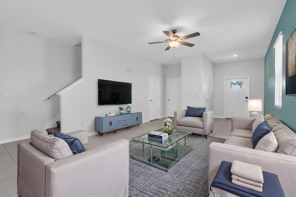 A kitchen features white cabinets, stainless steel appliances, and granite countertops — 8299 BIRCH HAVEN LANE, NEW PORT RICHEY, FL