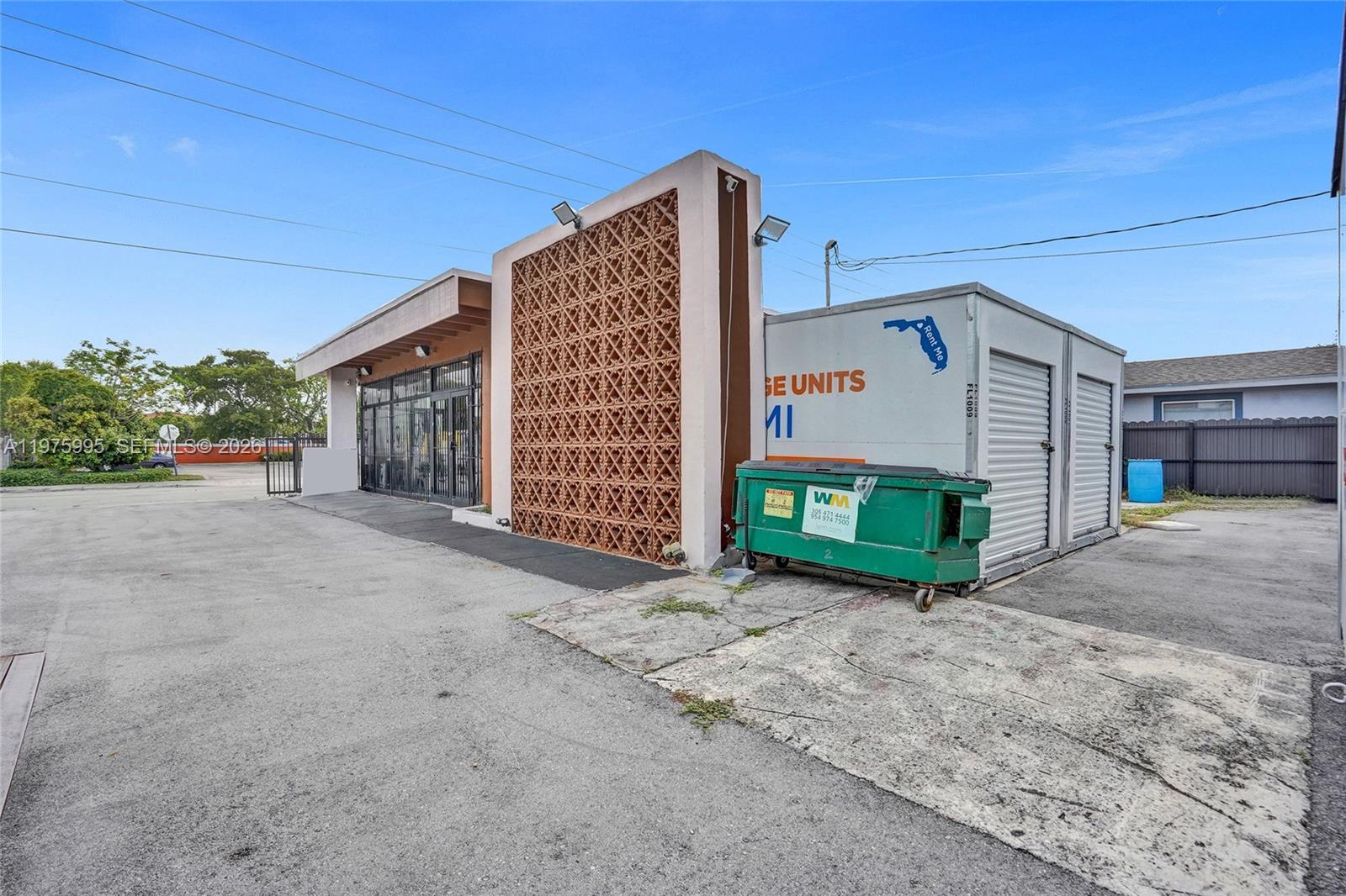 A commercial building exterior features a decorative breeze block wall and a portable storage unit — 5595 NW 17th Ave, Miami FL 33142, MIAMI, FL