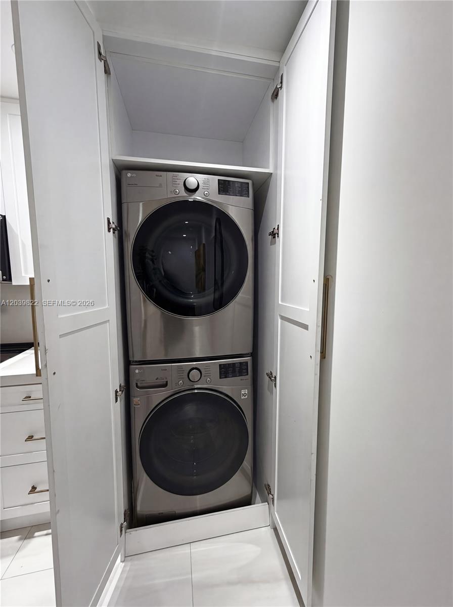 A stacked LG washer and dryer unit is enclosed within a white cabinet — 4712 SW 64th Ct, Miami FL 33155, MIAMI, FL