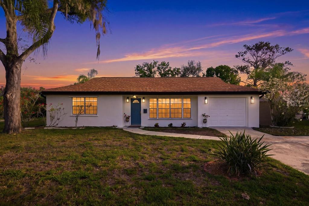 A single-story house with a white exterior, orange roof, and an attached one-car garage — 3705 GRAYTON DRIVE, NEW PORT RICHEY, FL
