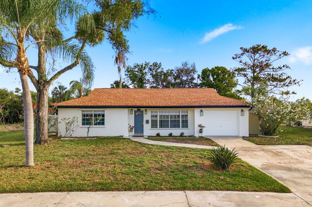 A single-story house with a white exterior, orange roof, and a large tree in front — 3705 GRAYTON DRIVE, NEW PORT RICHEY, FL