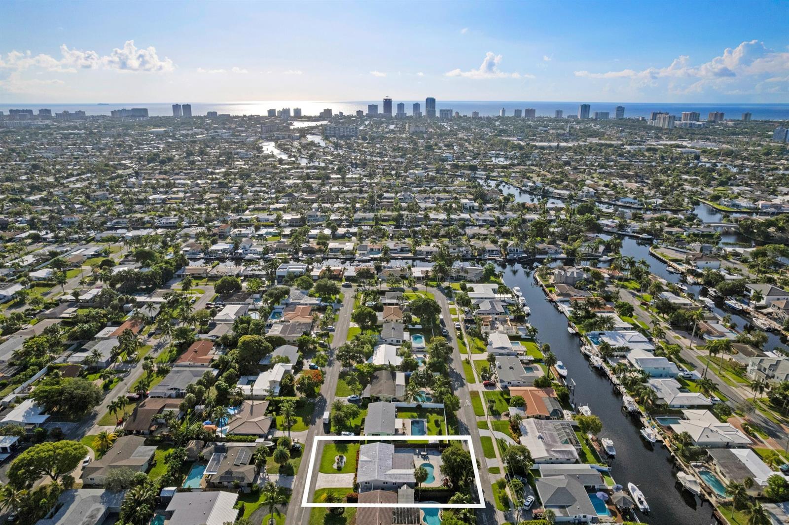 An aerial view shows a single-story house with a pool in a waterfront residential neighborhood — 300 SE 8th Court, Pompano Beach FL 33060, POMPANO BEACH, FL