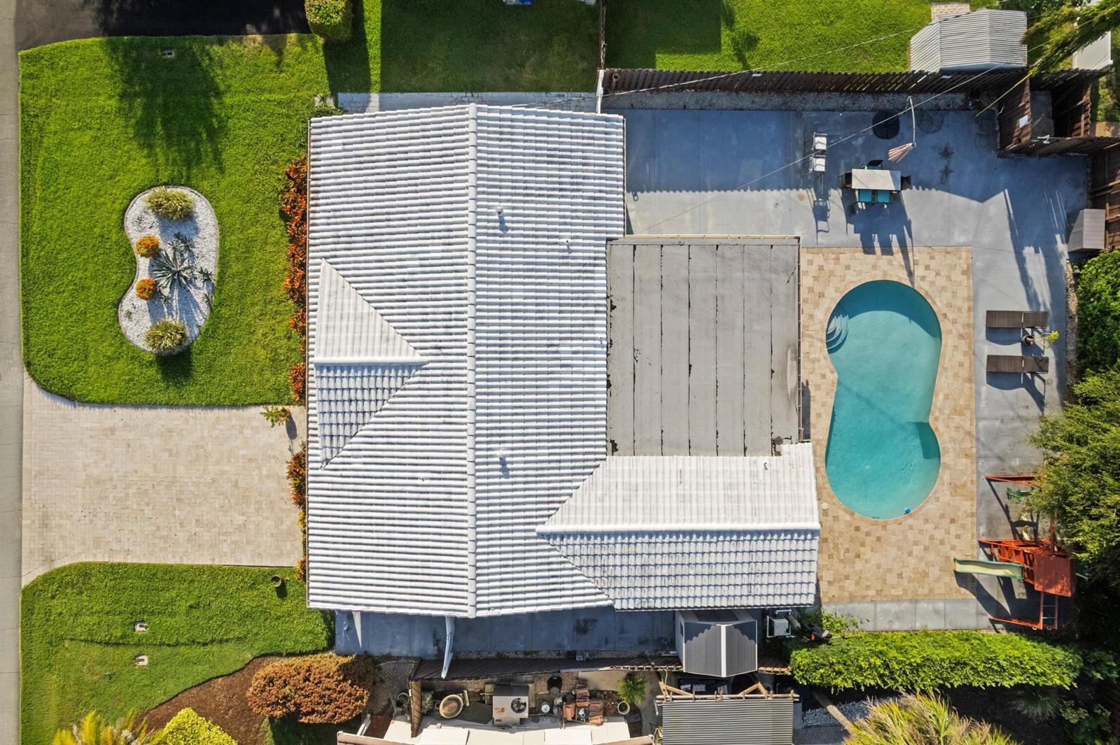 An aerial view of a house with a tiled roof, a swimming pool, and landscaped yard — 300 SE 8th Court, Pompano Beach FL 33060, POMPANO BEACH, FL