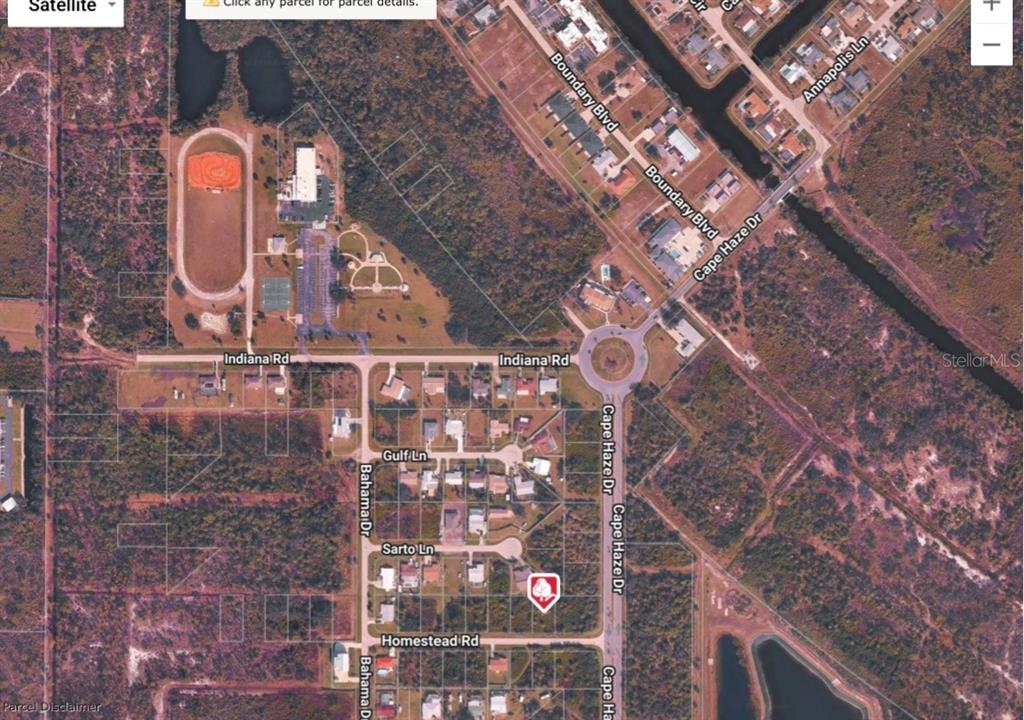 This is a satellite map view of a residential area with roads and a park — 3470 HOMESTEAD RD, ROTONDA WEST, FL