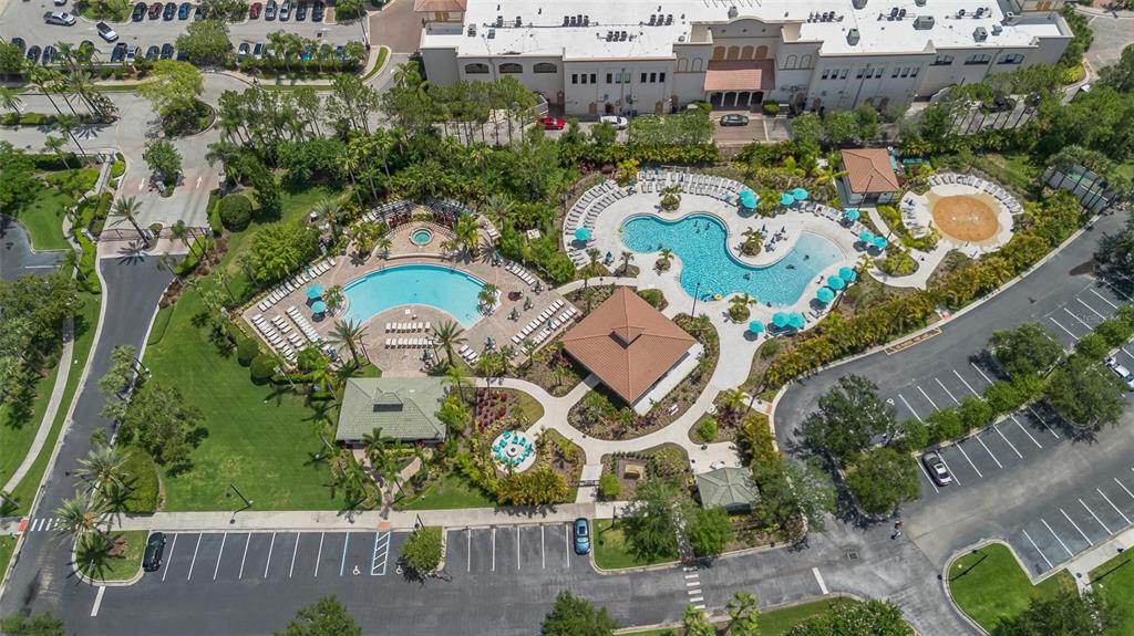 An aerial view shows a community swimming pool area with two pools and a clubhouse — 4114 BREAKVIEW DRIVE UNIT 110, ORLANDO, FL