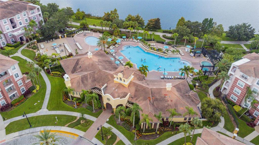 An aerial view shows a large apartment complex with a swimming pool and clubhouse — 4114 BREAKVIEW DRIVE UNIT 110, ORLANDO, FL