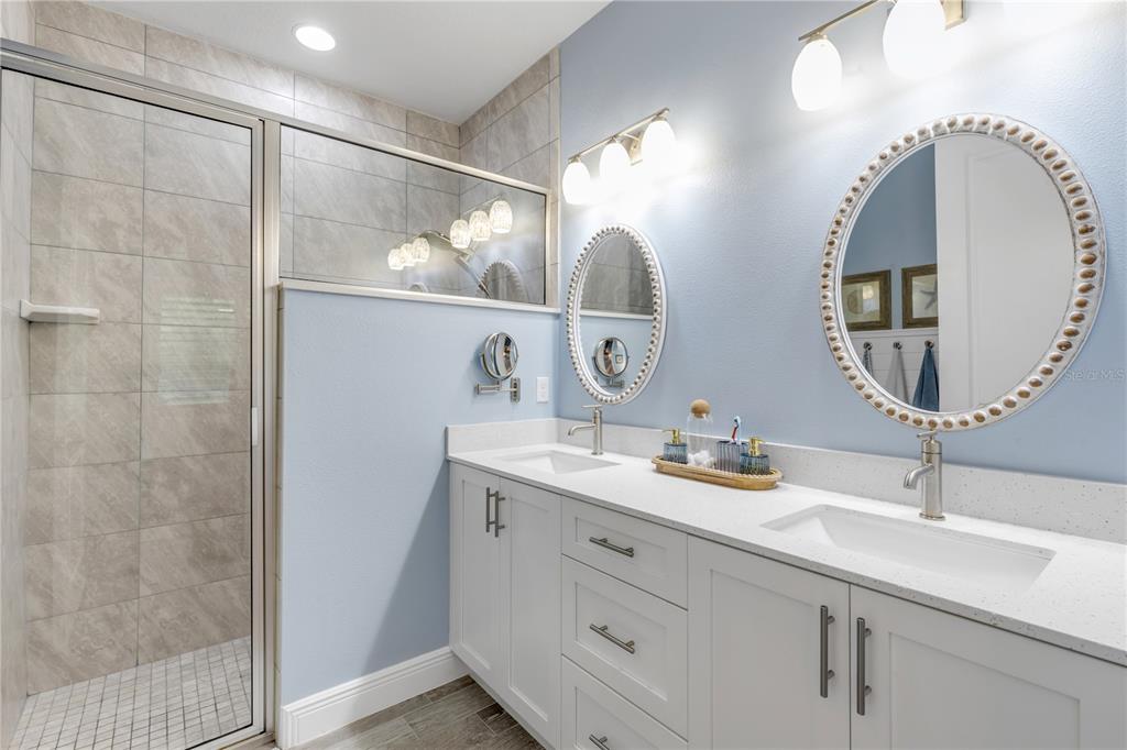 A kitchen featuring white cabinets, stainless steel appliances, and a blue subway tile backsplash — 47 WRENDALE LOOP, ORMOND BEACH, FL