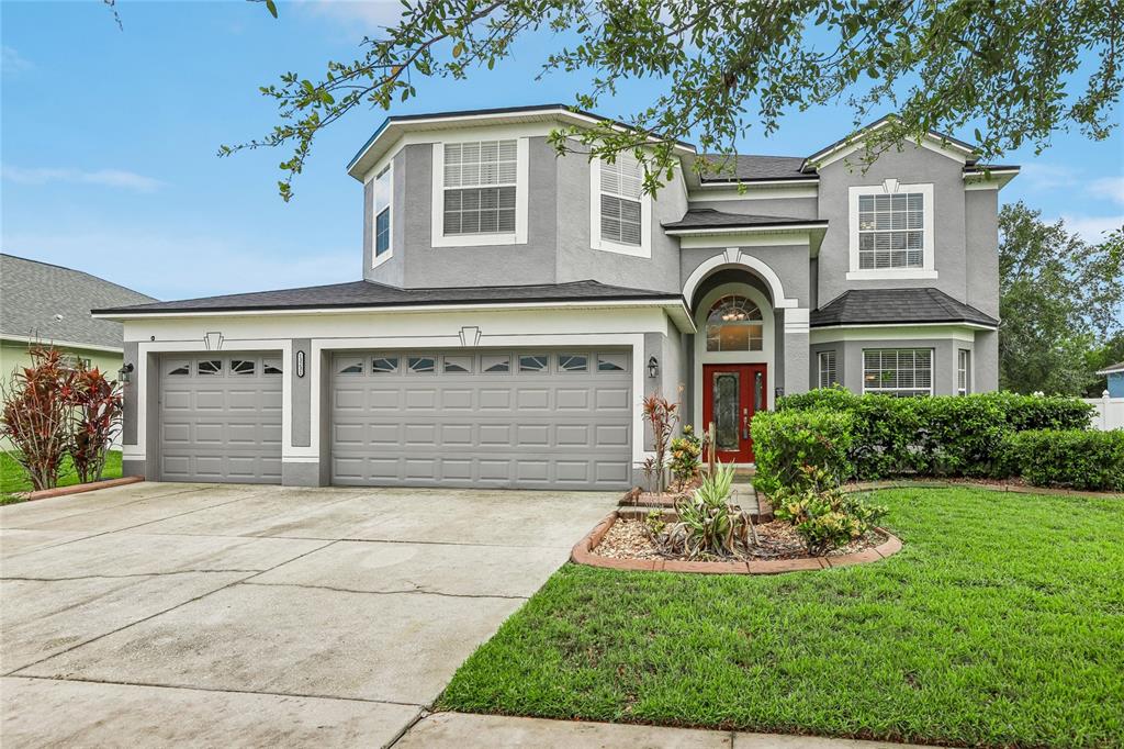 A two-story gray house with a two-car garage and a manicured front lawn — 13231 GRAHAM YARDEN DRIVE, RIVERVIEW, FL