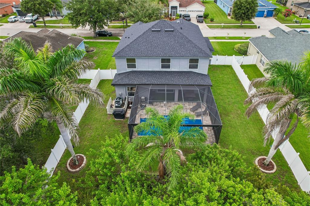 An aerial view shows a two-story house with a screened-in pool and fenced backyard — 13231 GRAHAM YARDEN DRIVE, RIVERVIEW, FL