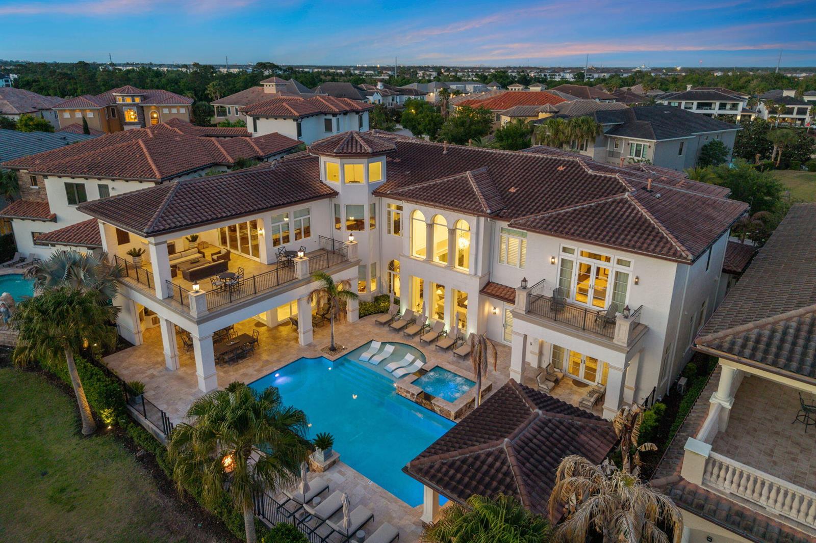 An aerial view of a large two-story house with a pool, patio, and tiled roof — 430 Muirfield Loop, Kissimmee FL 34747, KISSIMMEE, FL