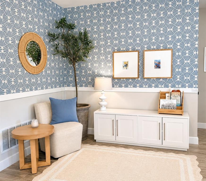 A bright entryway features a console table, a bench, and a hallway leading to a living area — 2419 PORTICO STREET, ODESSA, FL