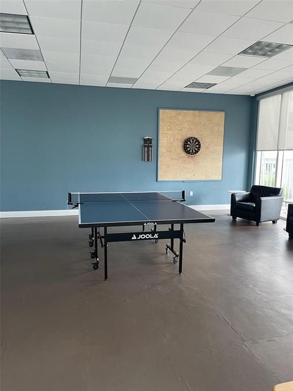 A game room features a ping pong table, a dartboard on the wall, and flooring — 241 RIVERSIDE DRIVE UNIT 410, DAYTONA BEACH, FL