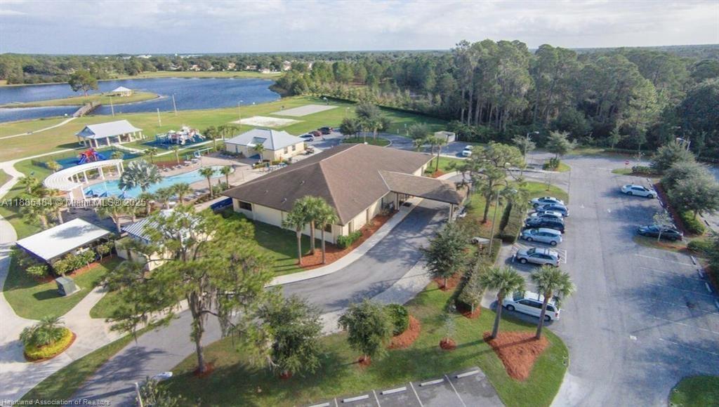 An aerial view shows a community clubhouse with a pool, playground, and parking lot — 4725 MAYA St, Sebring FL 33872, SEBRING, FL