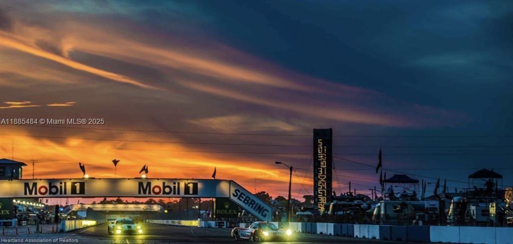 Two race cars drive under a Mobil 1 bridge at the Sebring International Raceway — 4725 MAYA St, Sebring FL 33872, SEBRING, FL