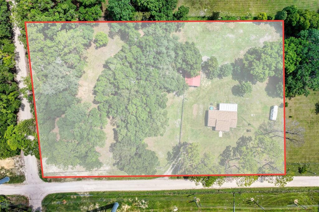 An aerial view shows a house and shed on a large, partially wooded lot — 18950 NE 55TH STREET, WILLISTON, FL