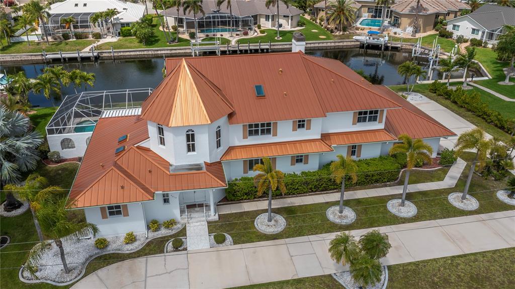An aerial view of a white two-story house with a copper-colored metal roof — 5019 BAL HARBOR BOULEVARD, PUNTA GORDA, FL