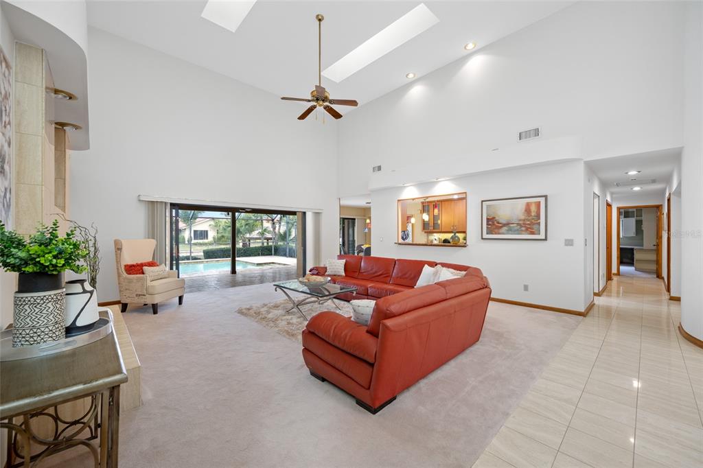 A wooden dock with a covered gazebo extends into a canal beside a residential backyard — 9807 COMPASS POINT WAY, TAMPA, FL