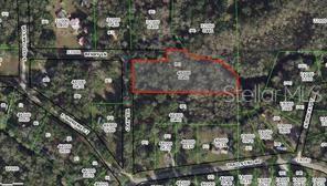 This is an aerial map showing a highlighted rectangular parcel of land surrounded by trees — 7521 S CLAY TERRACE, FLORAL CITY, FL