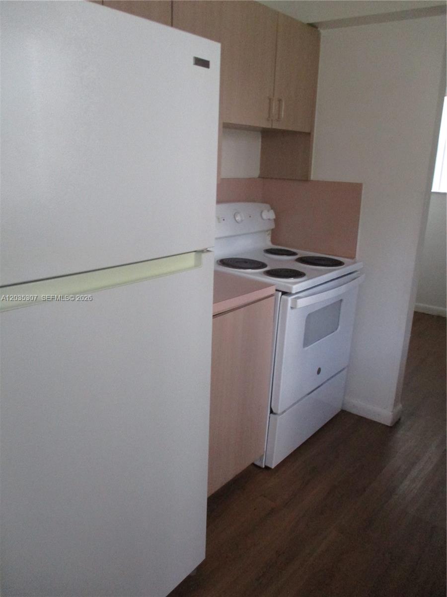 A kitchen features a white refrigerator, a white electric stove, and light wood cabinets — 10622 SW 174th Ter # 10622, Miami FL 33157, MIAMI, FL