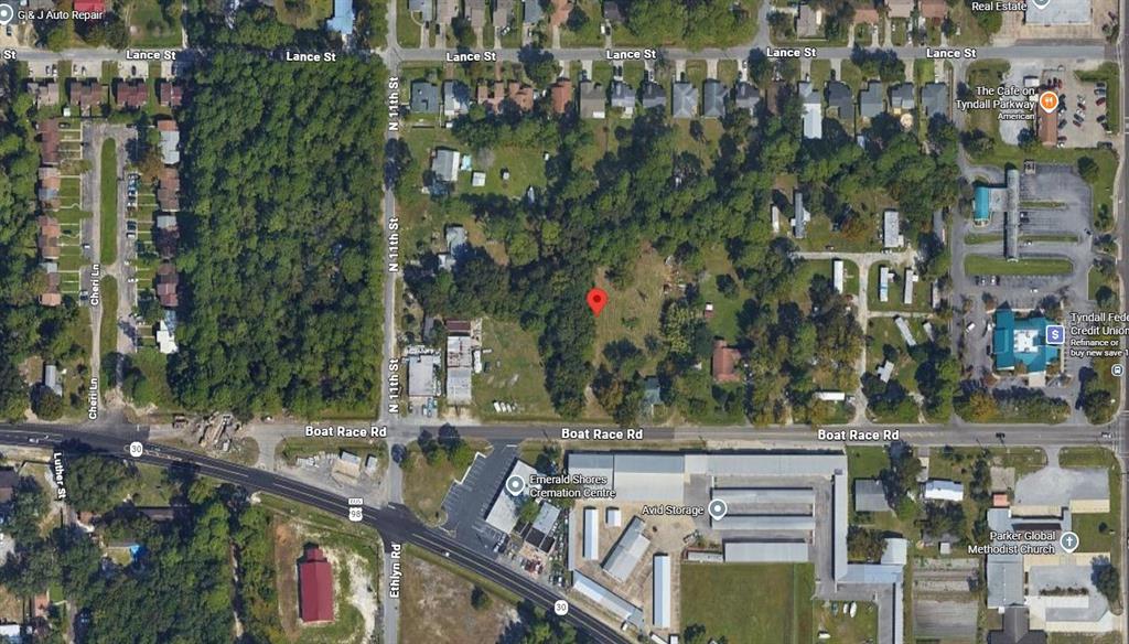 This is an aerial map view showing a vacant wooded lot marked with a red pin — 5321 BOAT RACE ROAD, PANAMA CITY, FL