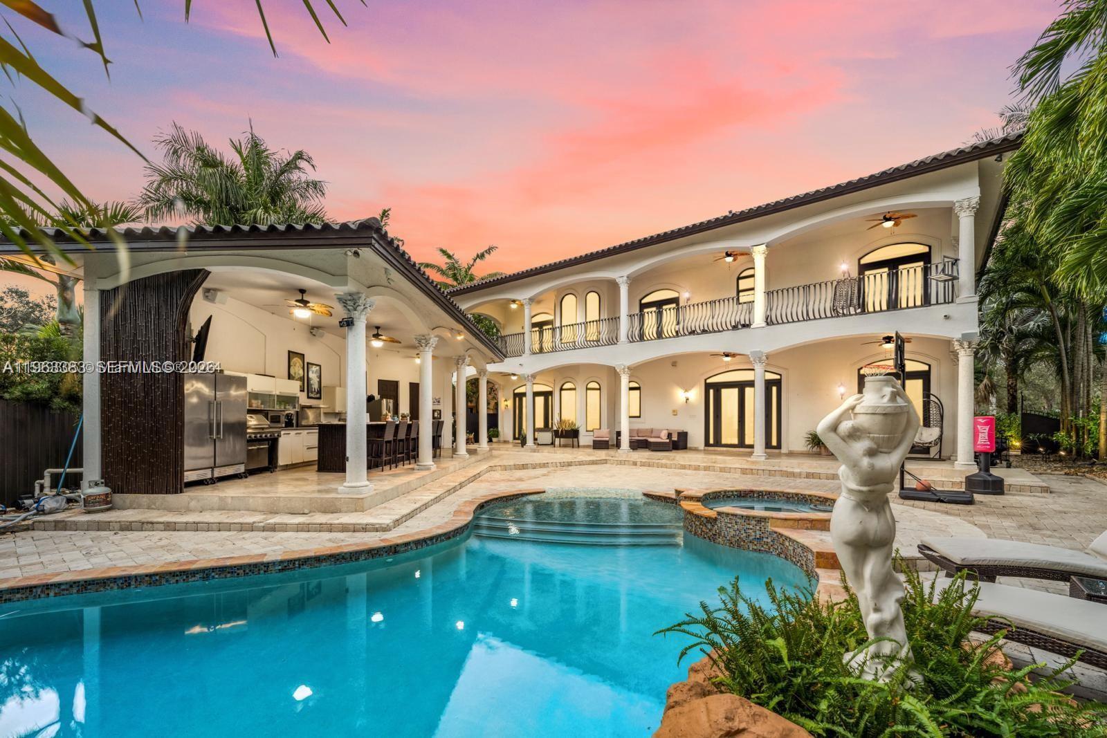A two-story house with a pool, patio, and outdoor kitchen at sunset — 8200 NW 163rd St, Miami Lakes FL 33016, MIAMI LAKES, FL