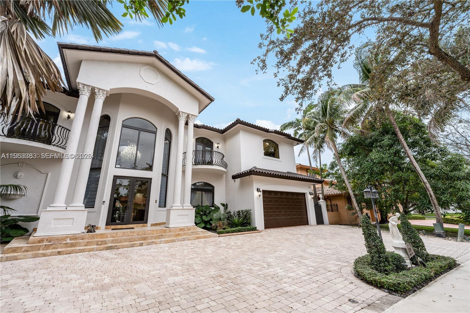 A two-story white stucco house features a grand entrance with columns and a paved driveway — 8200 NW 163rd St, Miami Lakes FL 33016, MIAMI LAKES, FL
