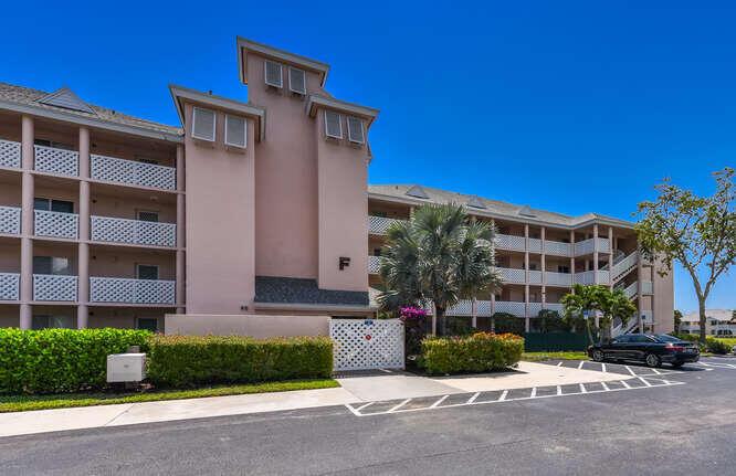 A multi-story pink apartment building with white lattice balconies and a paved parking lot — 353 S Us Highway 1 # F306, Jupiter FL 33477, JUPITER, FL
