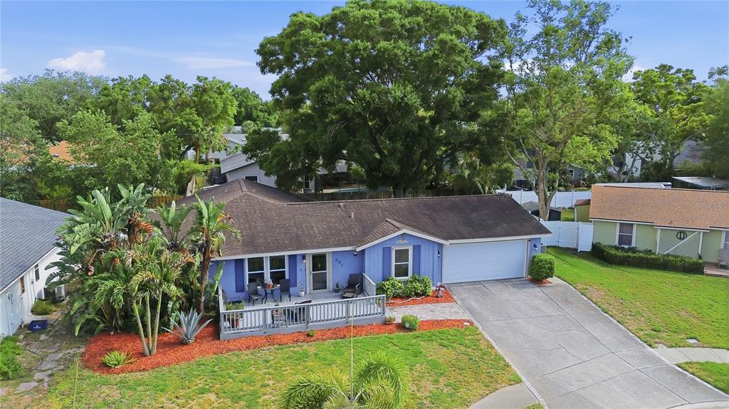 An aerial view of a blue single-story house with a front deck and driveway — 391 WALNUT COURT, PALM HARBOR, FL