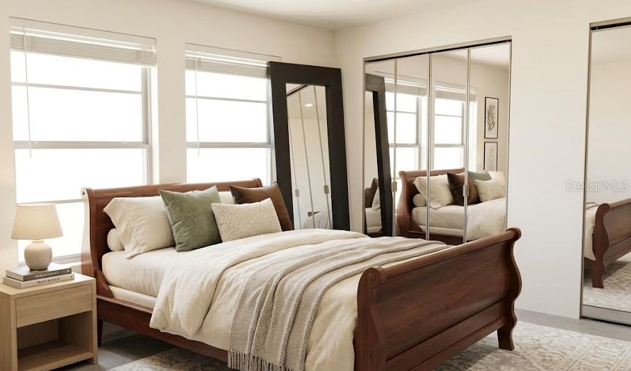 A bedroom features a wooden sleigh bed, a floor mirror, and mirrored closet doors — 1221 SE 24TH ROAD, OCALA, FL