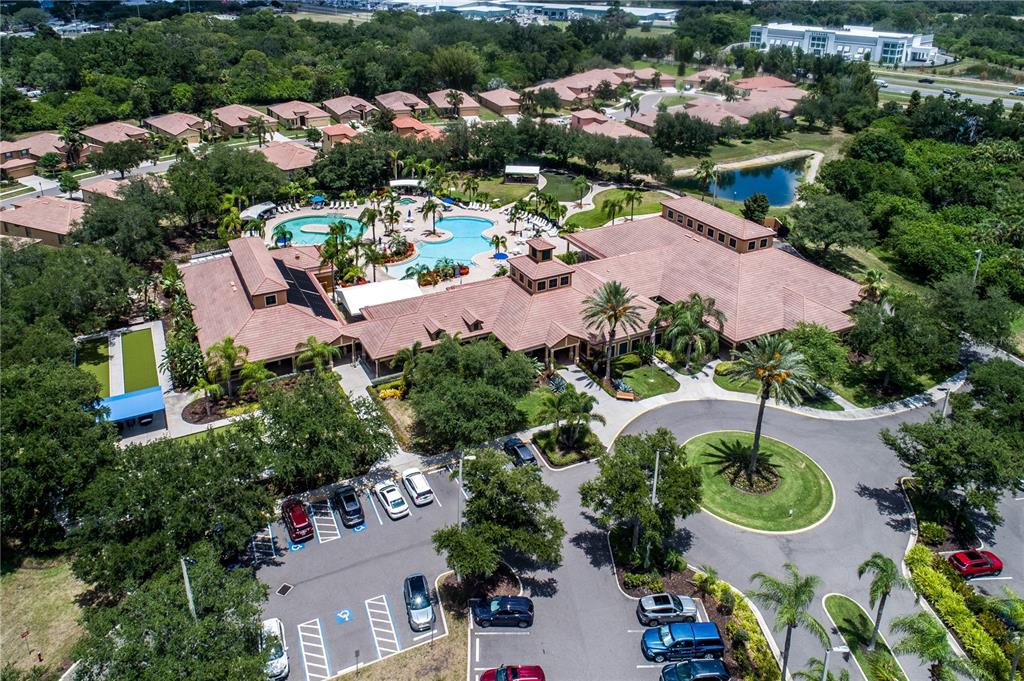 An aerial view shows a community clubhouse with a swimming pool and surrounding parking lot — 312 SENECA FALLS DRIVE, APOLLO BEACH, FL