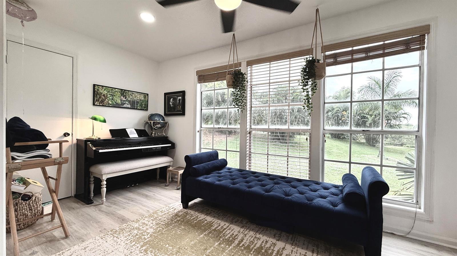 A room features a piano, a blue tufted chaise lounge, and windows overlooking a yard — 5016 Heatherhill Lane # 10, Boca Raton FL 33486, BOCA RATON, FL
