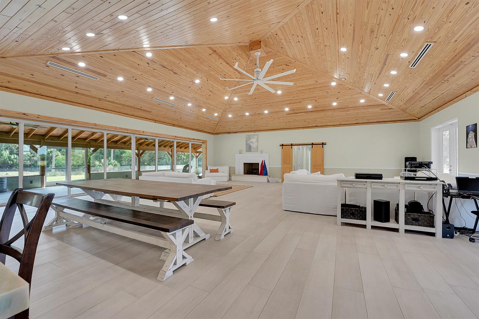 A spacious living area features a vaulted wood-paneled ceiling, recessed lighting, and a dining table — 3901 Wild Turkey Trail Trail, Okeechobee FL 34974, OKEECHOBEE, FL