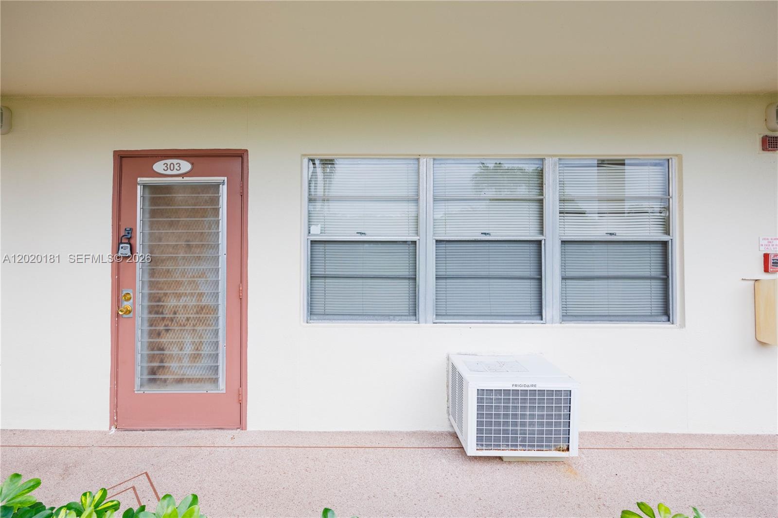 An exterior view shows a door labeled 303, a window, and a wall-mounted air conditioner — 303 Preston H # 303, Boca Raton FL 33434, BOCA RATON, FL