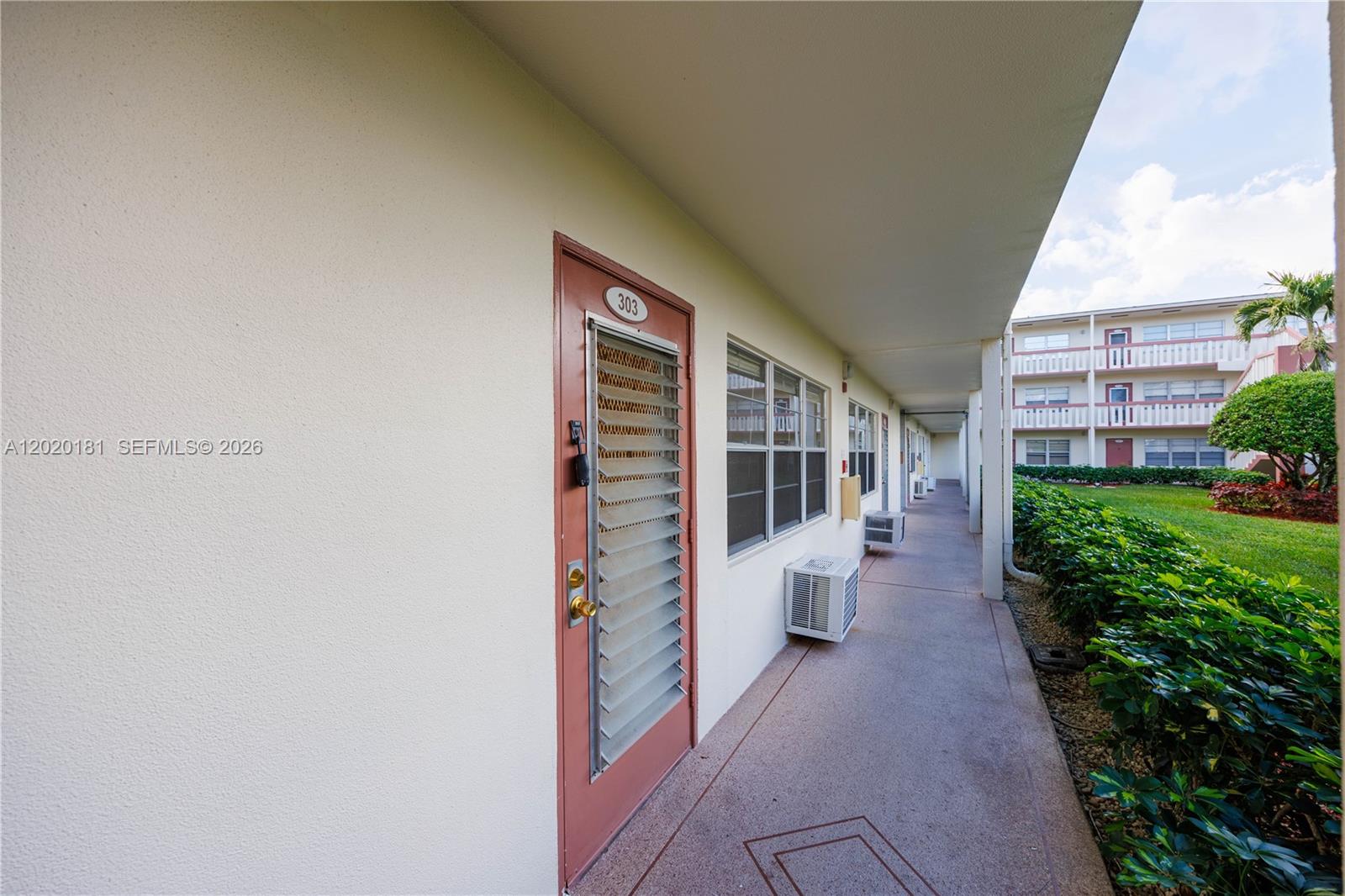 An exterior walkway leads past a door labeled 303 and several wall-mounted air conditioning units — 303 Preston H # 303, Boca Raton FL 33434, BOCA RATON, FL